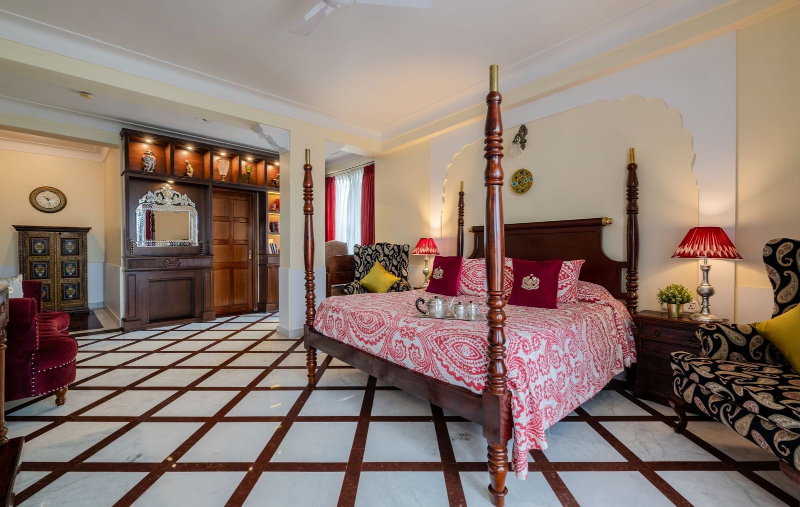  Guest bedroom with pink bedding, lampshade, and black-and-white tiled flooring at Dera Rawatsar, Jaipur.