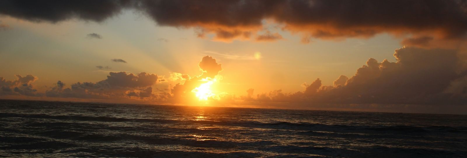 A Golden sunset view from the shore with calm waters