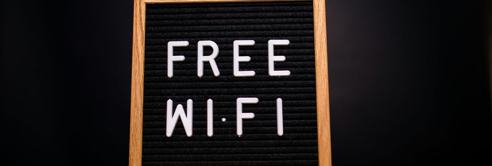 Free Wi-Fi sign displayed on a wooden stool.