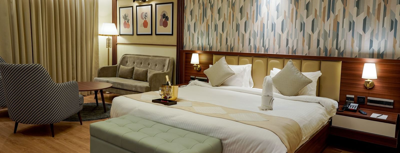 Corner view of the double bed in the Premium Room along with a common seating area in the corner of the room at M2 Square by Monday Premium.