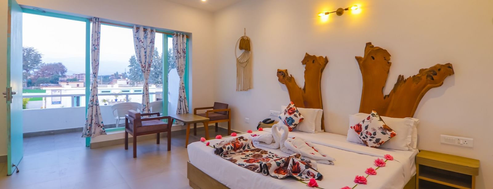 A uniquely decorated bedroom at Vedikant Resorts The Mallard Corbett features a bed adorned with flowers and seating.