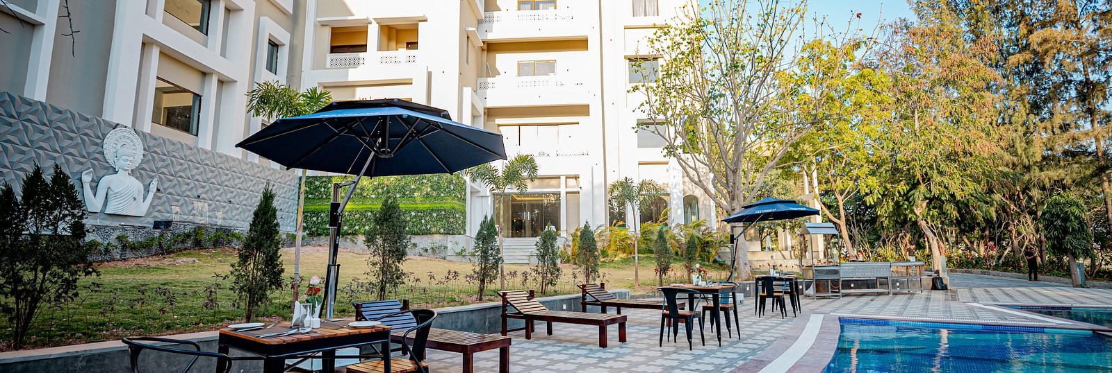 A view of the dining setting placed by the pool at Essentia Luxury Resort & Spa, Udaipur.
