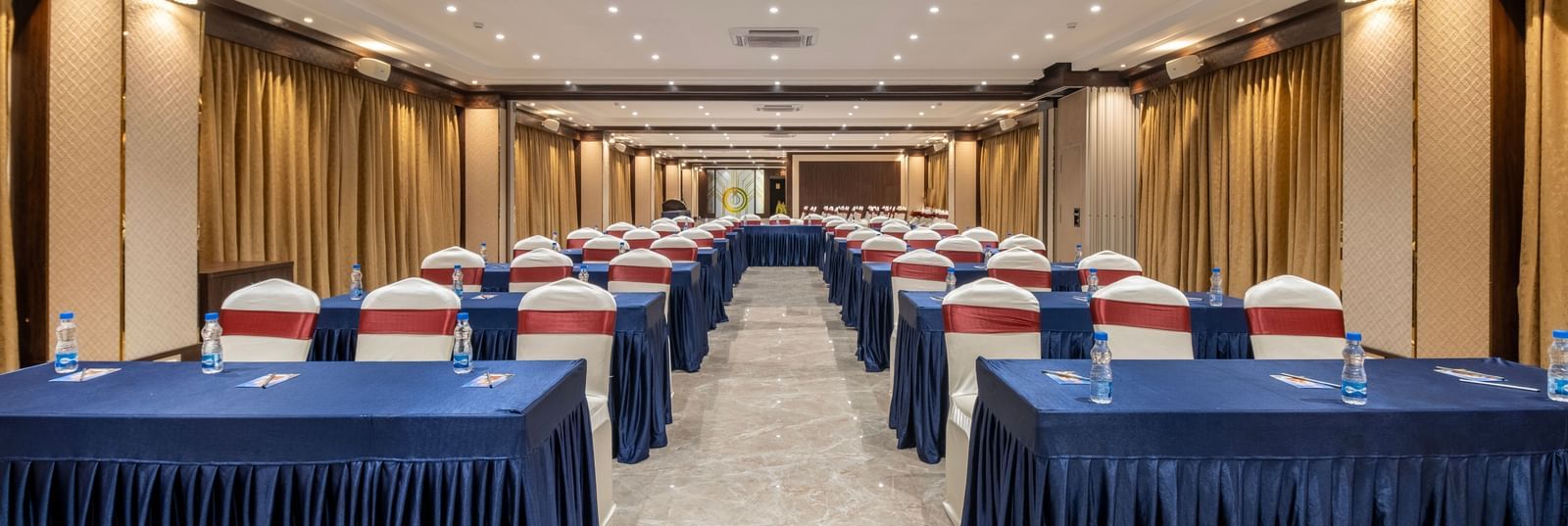 Spacious hall at Monday Hotels Amalapuram Heights with classroom seating arrangement.