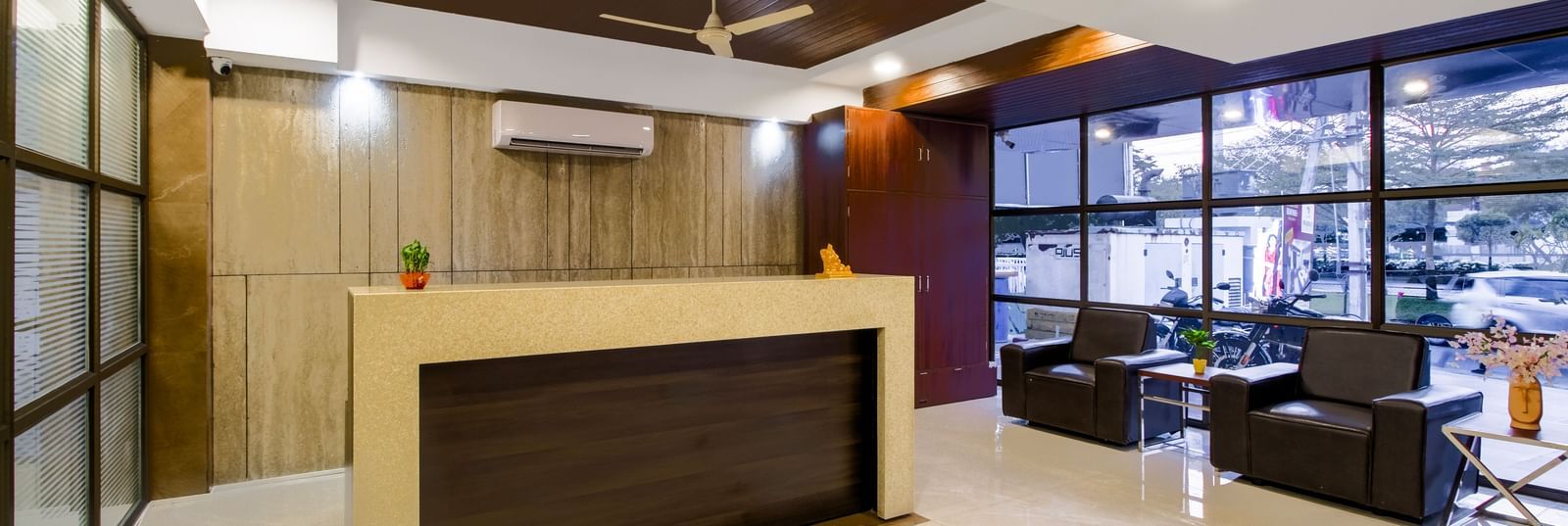 Reception desk with seating area polished flooring and contemporary design at Swarna's The Capital.