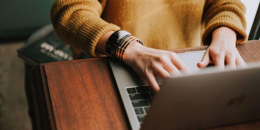 alt-text Man in Hoodie working on his laptop