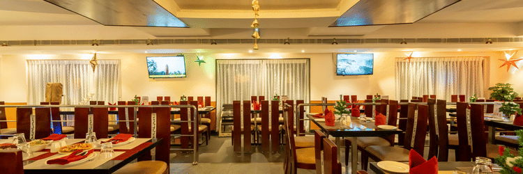 A warm-lit restaurant boasting a cosy ambience with sitting arrangements with chairs and tables