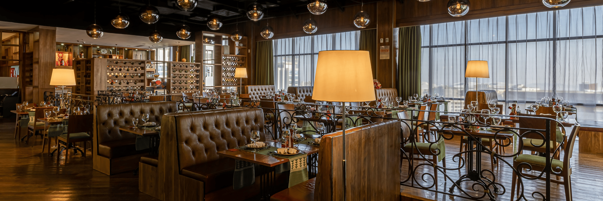Seating arrangements at Fogo No Chão restaurant, one of the best places to eat in Addis Ababa, with small chandeliers on the roof at Ramada by Wyndham Addis