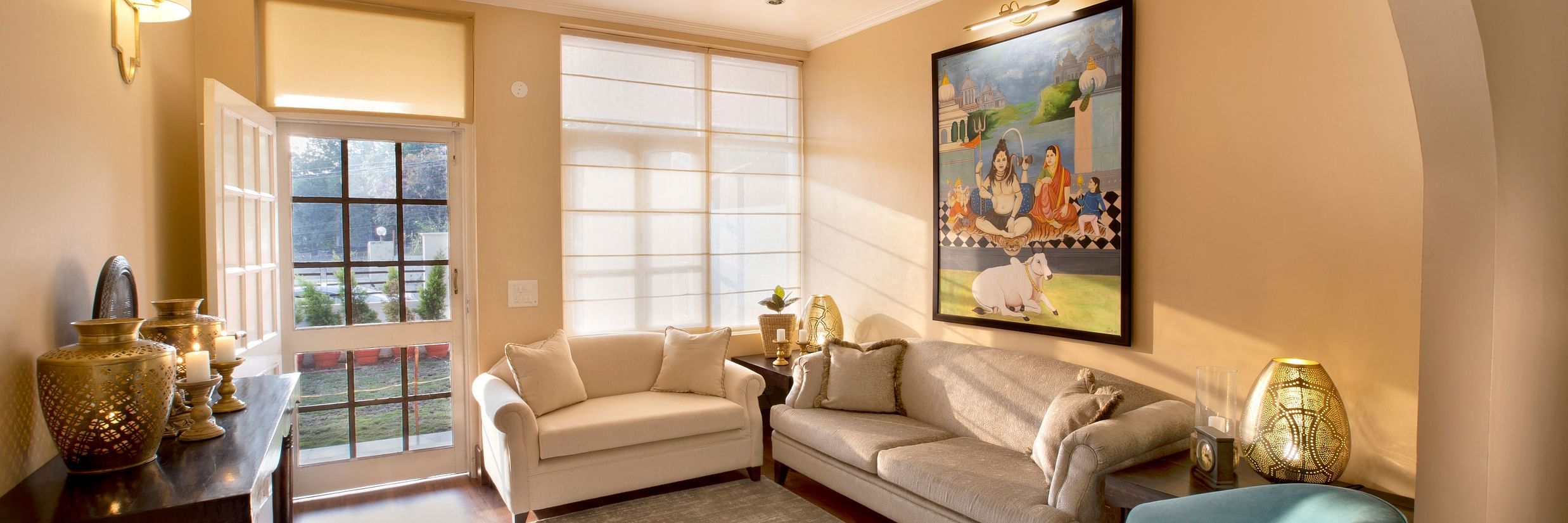 An image of a living room features comfy sofas and large windows 4 - Lamrin Boutique Cottages Rishikesh