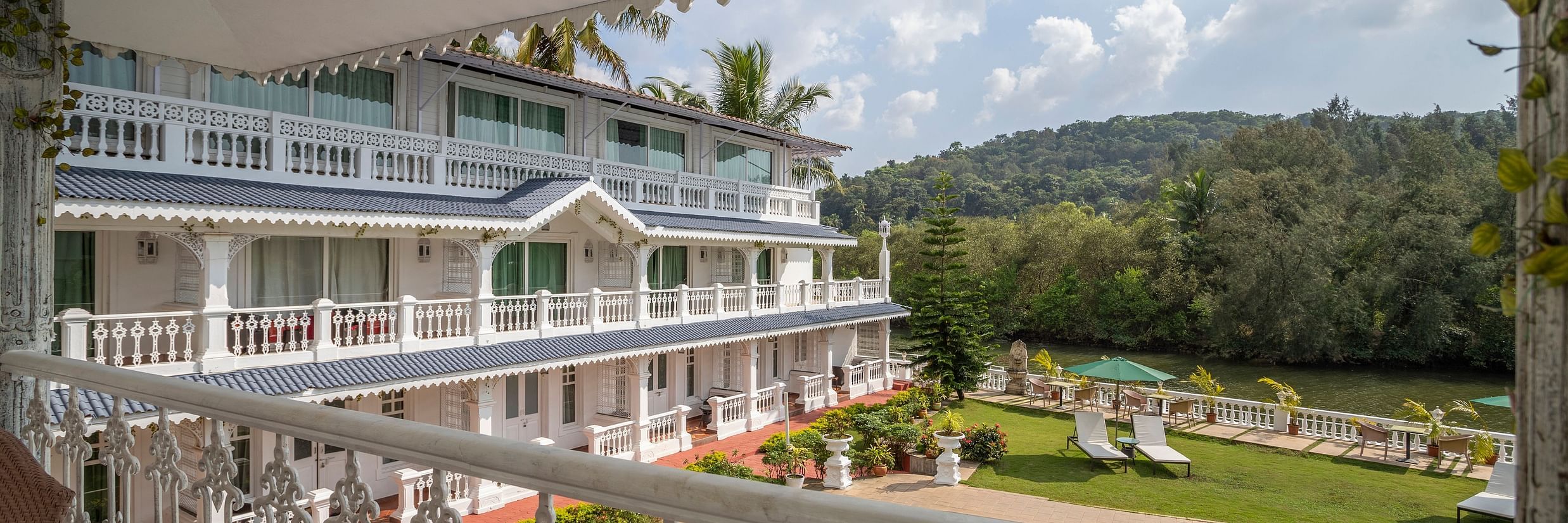 The Maharaja Balcony offers a splendid view of the facade, pool and thick vegetation surrounding the premise - Stone Wood Riverfront Resort, Siolim
