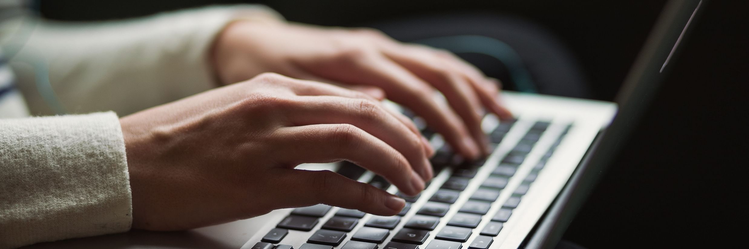 a person using a laptop - V Five Hotel