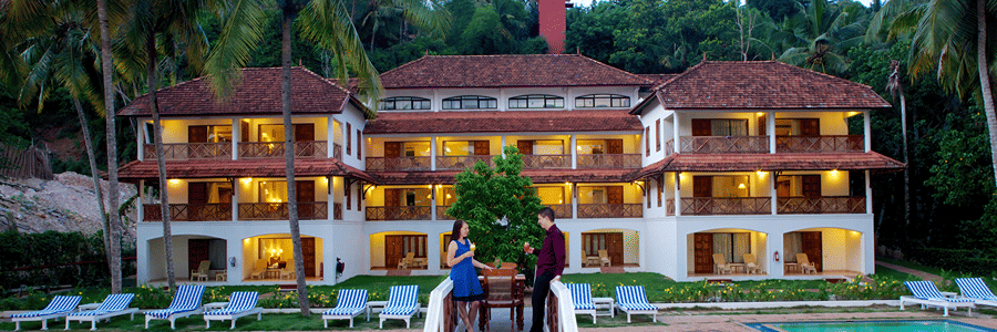 Facade of Beach Grove Room in front of a swimming pool at The Travancore Heritage Beach Resort
