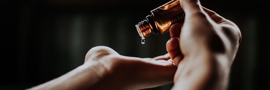 A person pouring oil onto their hands