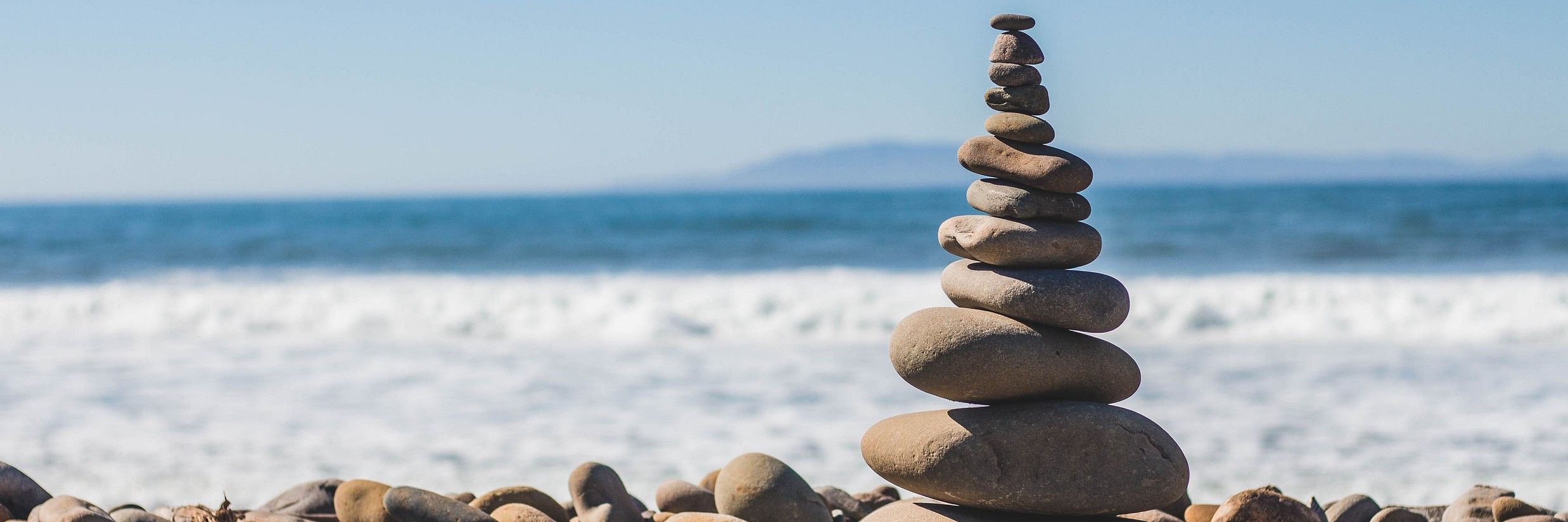 pebbles stacked on top of each other on the beach
