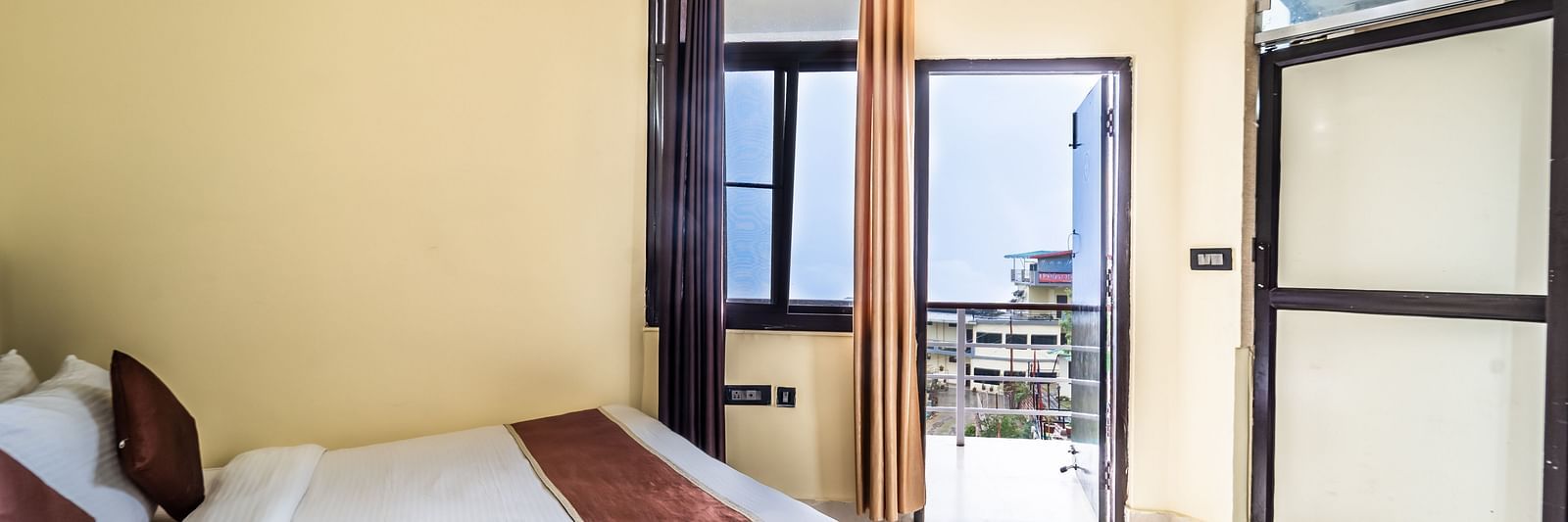 a room at Flutter Hotels & Resorts featuring a bed and a wardrobe