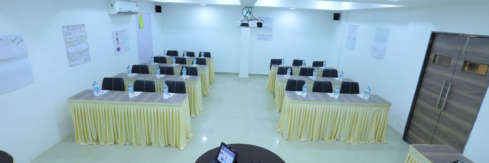Classroom seating arrangement, projector, air-conditioning in the spacious Olive banquet hall, with ample lighting, at Highland Resort.