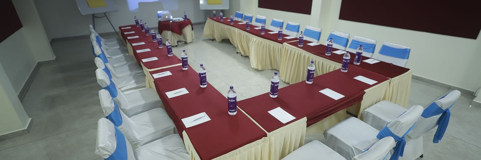 U-shaped arrangement in the Pearl banquet hall at Mountview Resort that is furnished with cloth-covered chairs and tables.