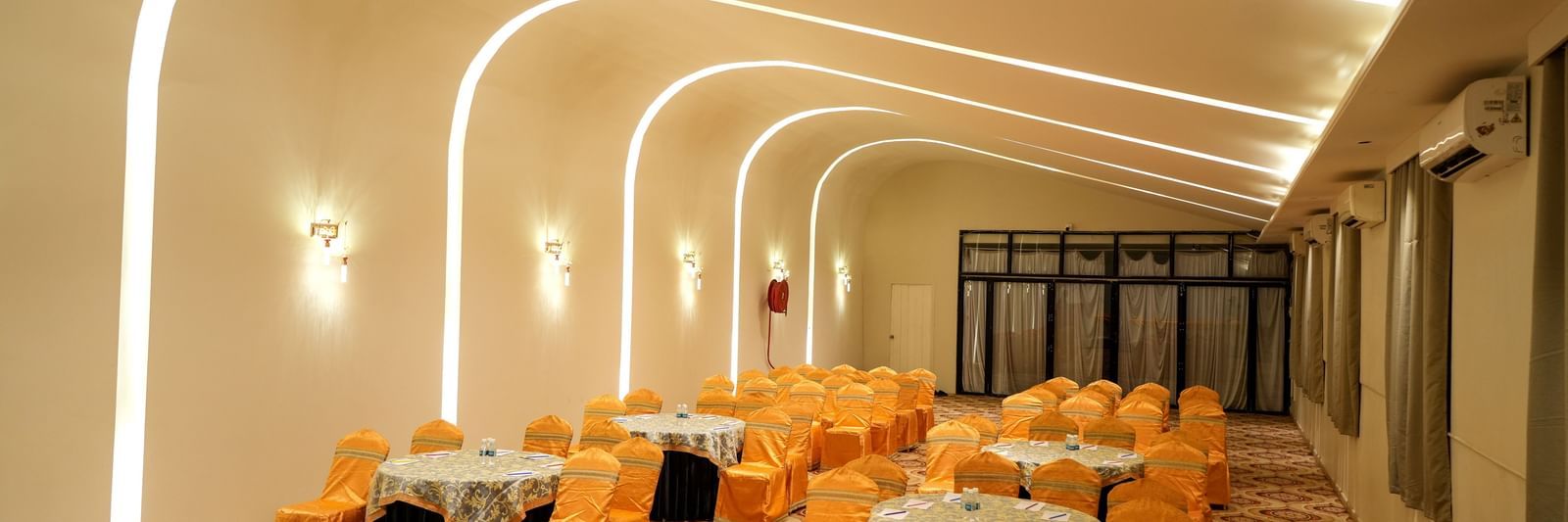 Elegant dining area with warm lighting and stylish seating at Pravasa Hotel Kolhapur.