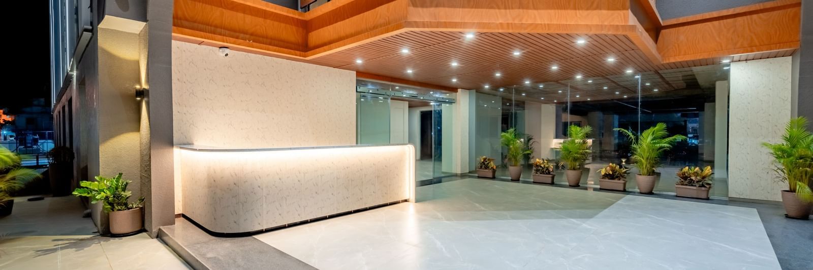 Lobby area of Pravasa Hotel with a front desk and ample lighting | Pravasa Hotel, Vijayapura