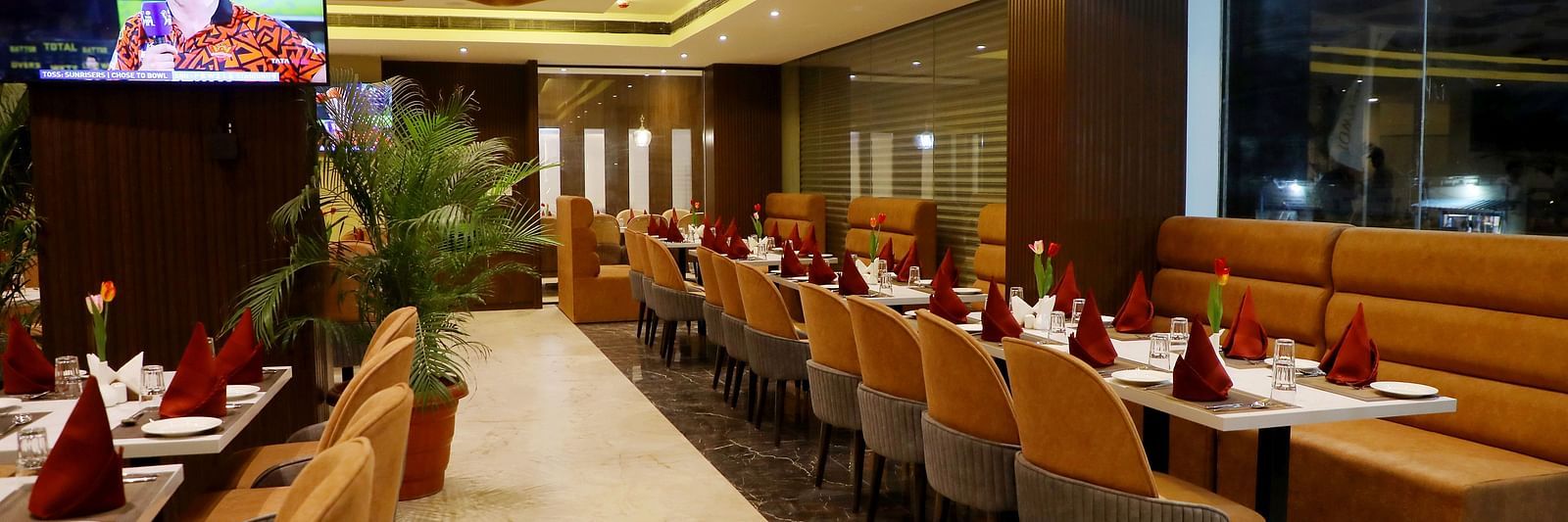 Spacious restaurant at Town Square Suites with modern interiors and ample seating arrangement