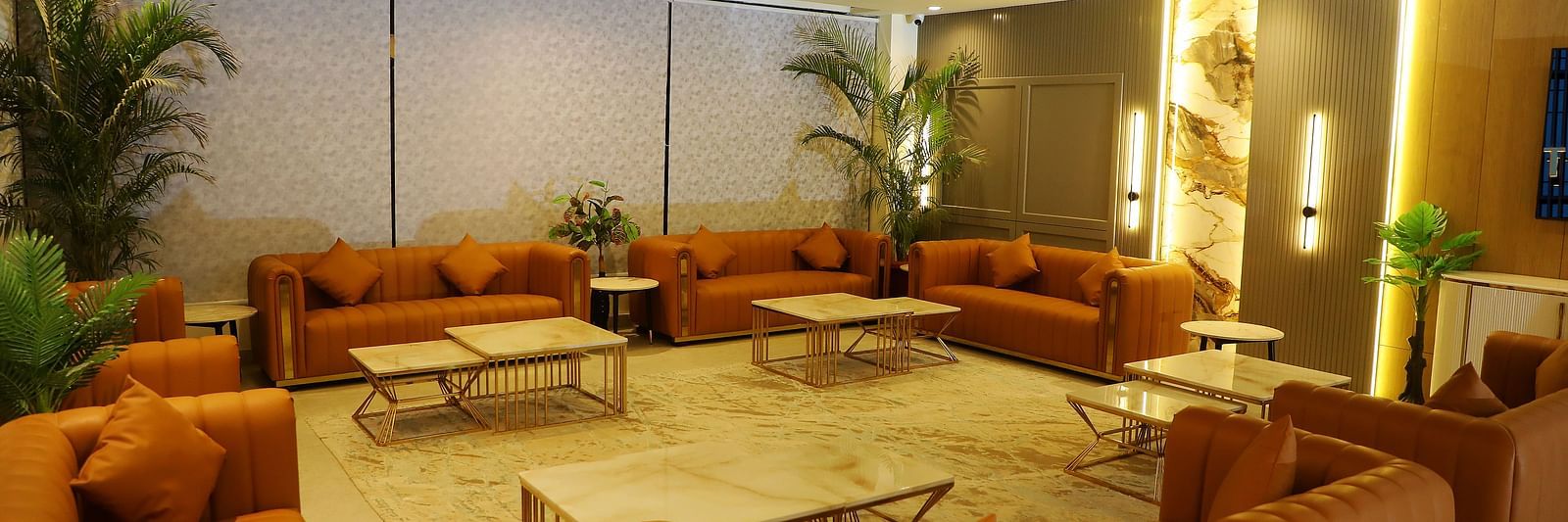 Elegant guest lounge at Town Square Suites with plush sofas and warm lighting