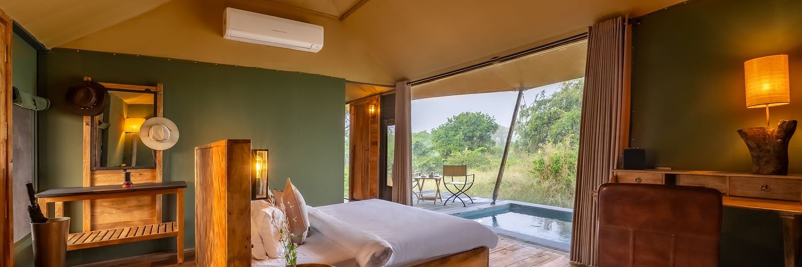 An interior of a room with double bed at Trees N Tigers, Tadoba.