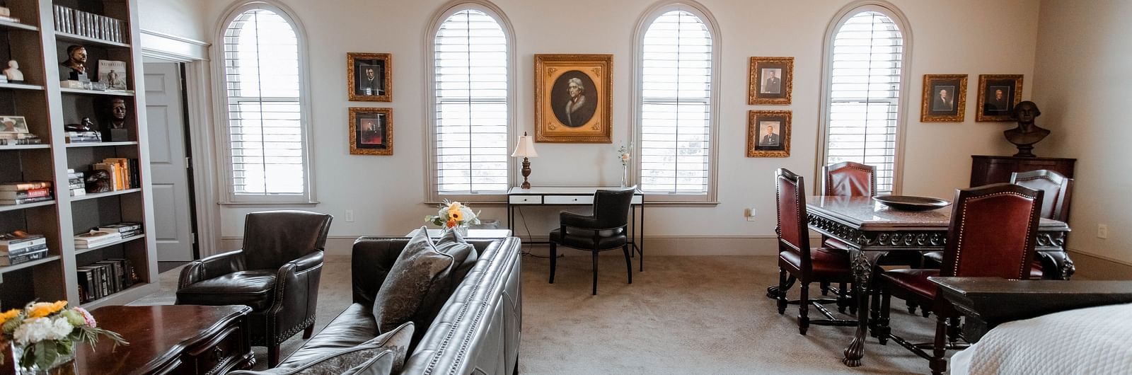  A spacious bedroom with a king-sized bed, wooden furniture, and soft lighting, creating a tranquil and elegant retreat - The Grand Hotel & Ballroom, McKinney