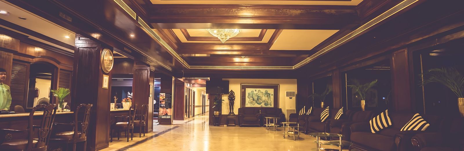 Interiors of the well-lit lobby area of Paradise Isle Beach Resort, Udupi with the reception desk towards the left