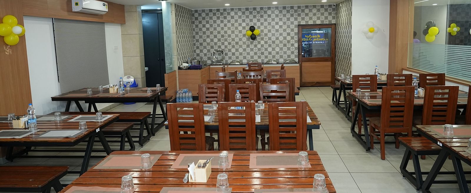 a top angle shot of the dining area featuring a table with six table mats placed over it - Hotel Grand Sigma