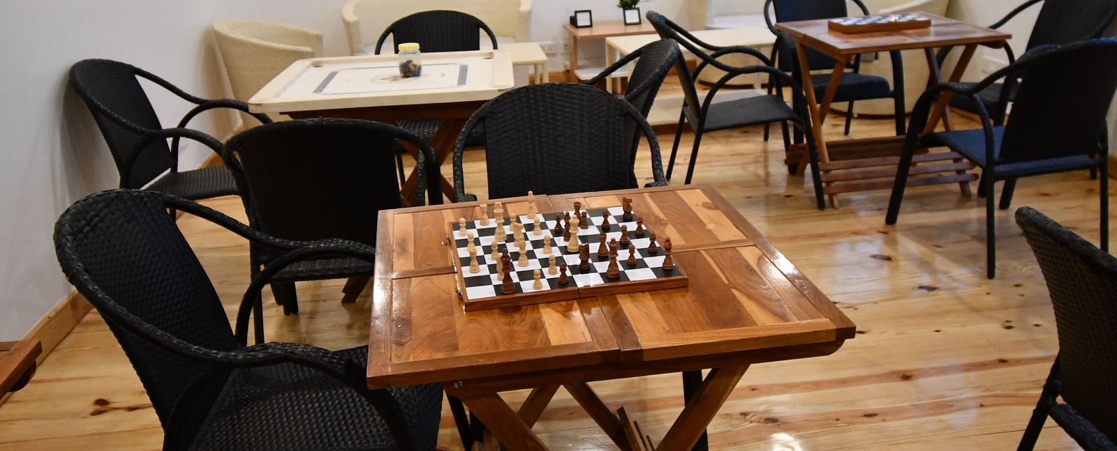 image of the indoor games area featuring a chess board kept on a wooden table at the tattva, joshimath