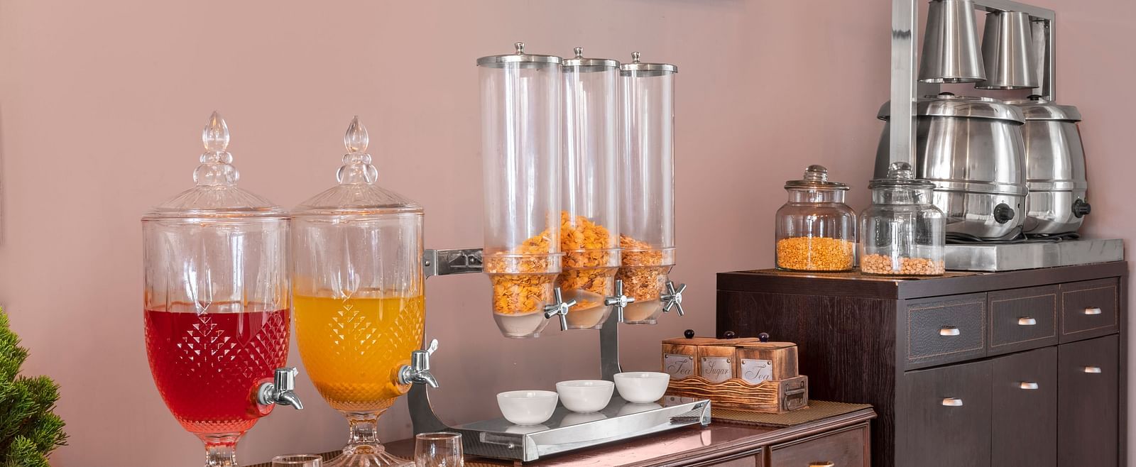 Self-serve breakfast counter with juice dispensers, cereals, and tea set-up, at BluSalzz Collection - Suvaasa Resort, Ramgarh.