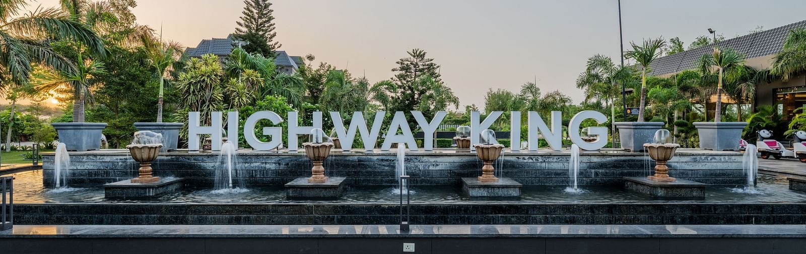 A shot of the signage of Highway king in the lawn of the hotel.