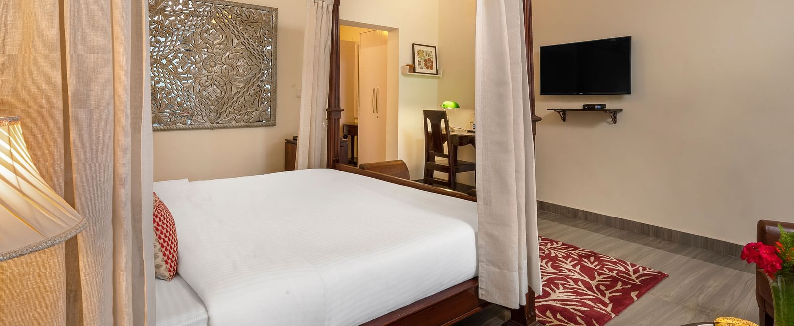 Comfortable suite with elegant furnishings, canopy bed, and flat-screen TV, at BluSalzz Collection - Suvaasa Resort, Ramgarh.