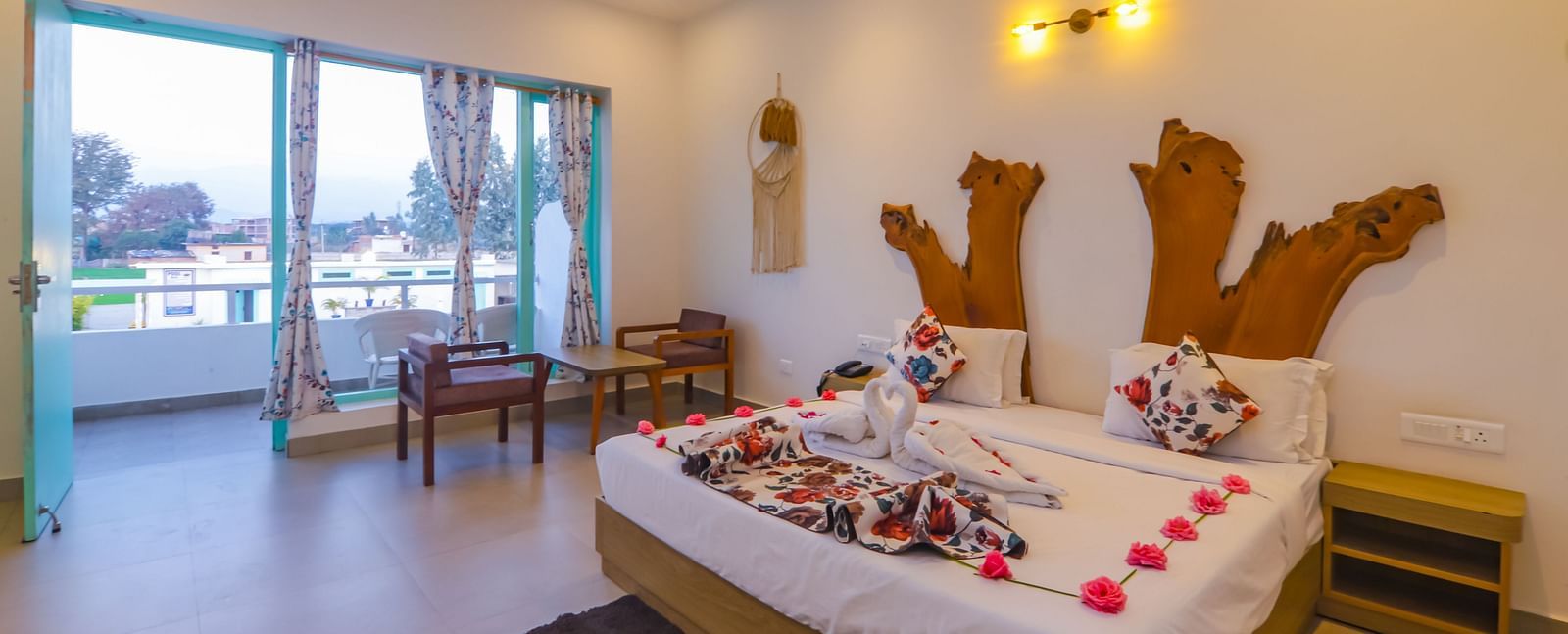 A uniquely decorated bedroom at Vedikant Resorts The Mallard Corbett features a bed adorned with flowers and seating.