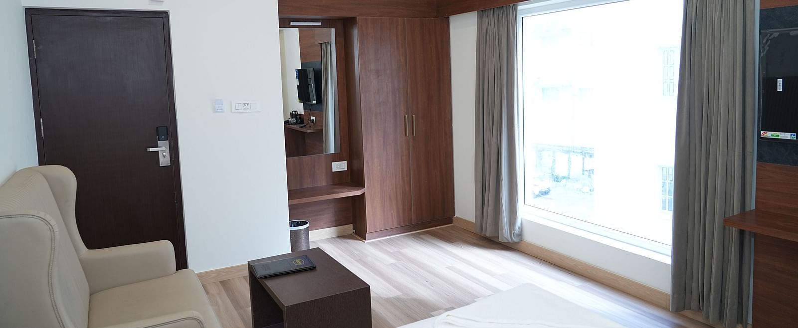 a top view shot of the premium executive room featuring a huge window with ample natural light coming into the room - Hotel Grand Sigma