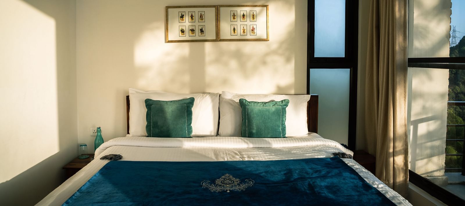 A bedroom with sunlight streaming through the windows at BluSalzz Escapade Resort, Lansdowne.