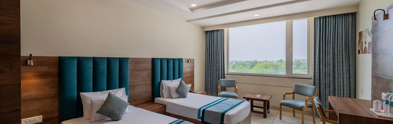 Spacious King Twin Bed Room with window seating, work station, ceiling fan, and modern amenities at Hotel Highway King, Bilaspur.
