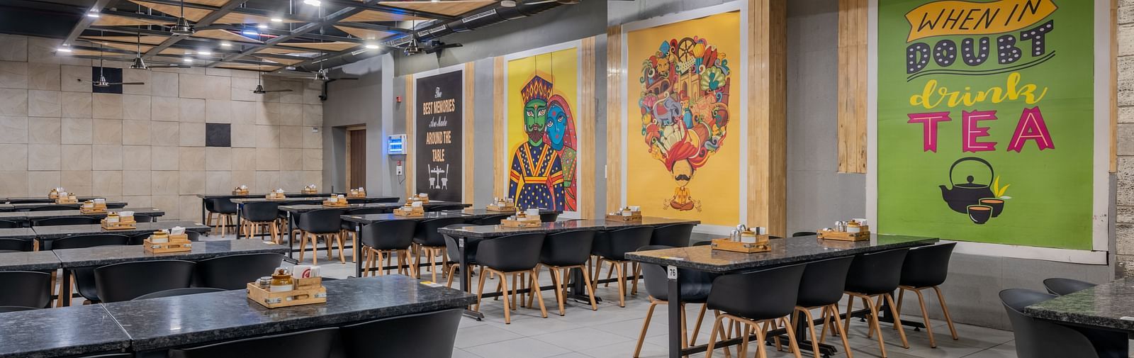 Spacious dining area with vibrant wall murals at Hotel Highway King restaurant.