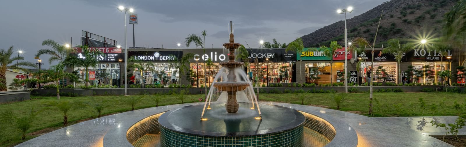 Exterior entrance showcasing water fountain feature at Hotel Highway King, Neelka.