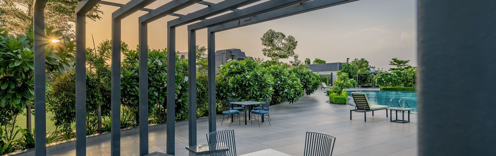 A modern outdoor dining or lounge area with a pergola at Hotel Highway King Shahpura.