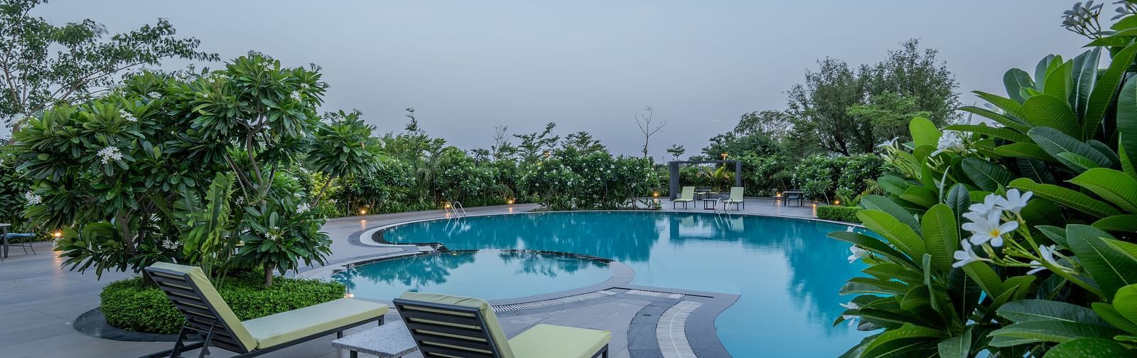 The Hotel Highway King Shahpura swimming pool with lounge chairs on the deck