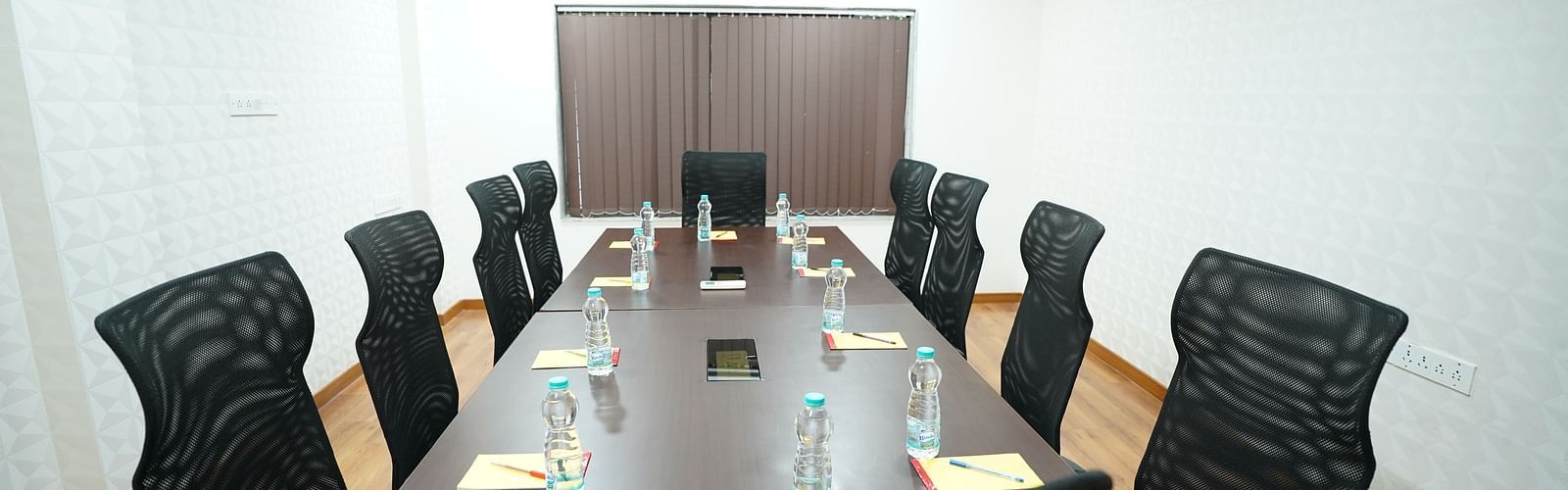an image of a close up shot of a boardroom with water bottles placed on the table at  City Centre Residency, Bangalore