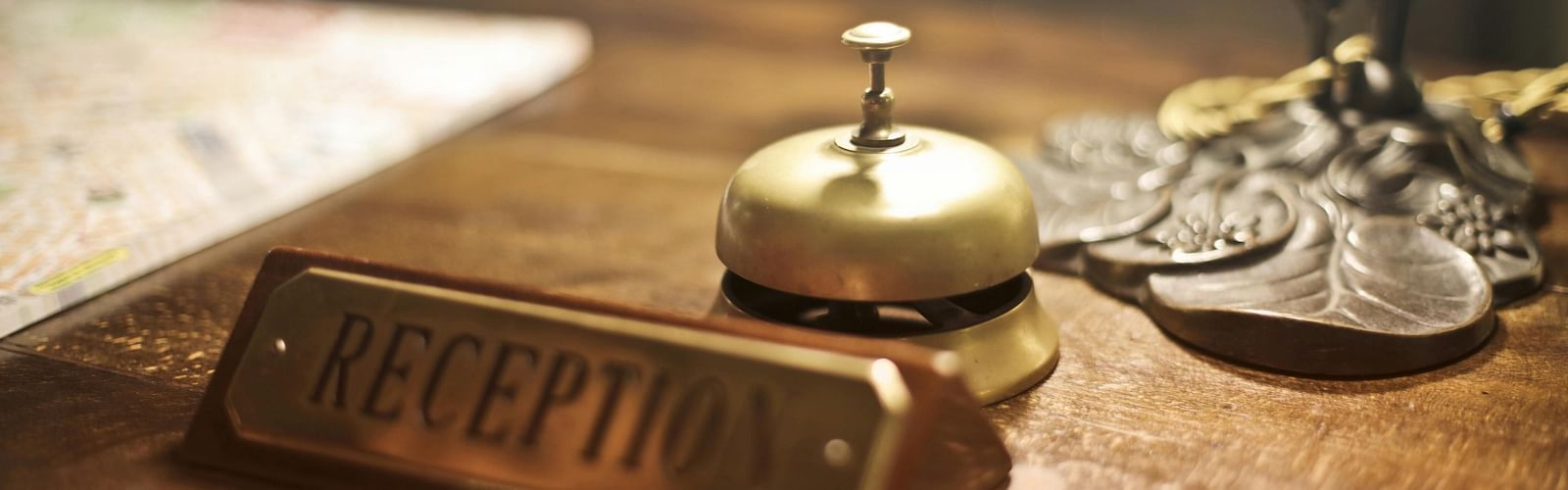 an image of close up shot of reception desk with a concierge bell