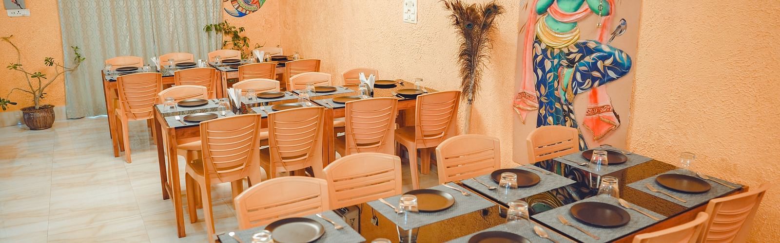 image of the fine dining restaurant at dip holidays at birbhum featuring an orange coloured interior