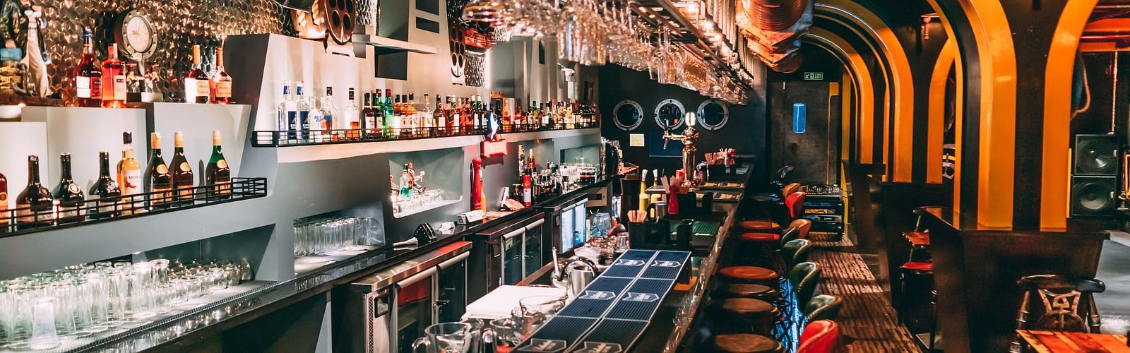 image of a bar counter with alcohol on display behind the counter - Hotel Park Elanza, Chennai