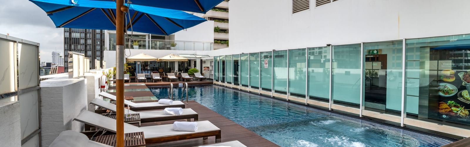 An overview of the rooftop swimming pool with loungers next to it - Night Hotel Bangkok - A Rooftop Pool Hotel in Bangkok