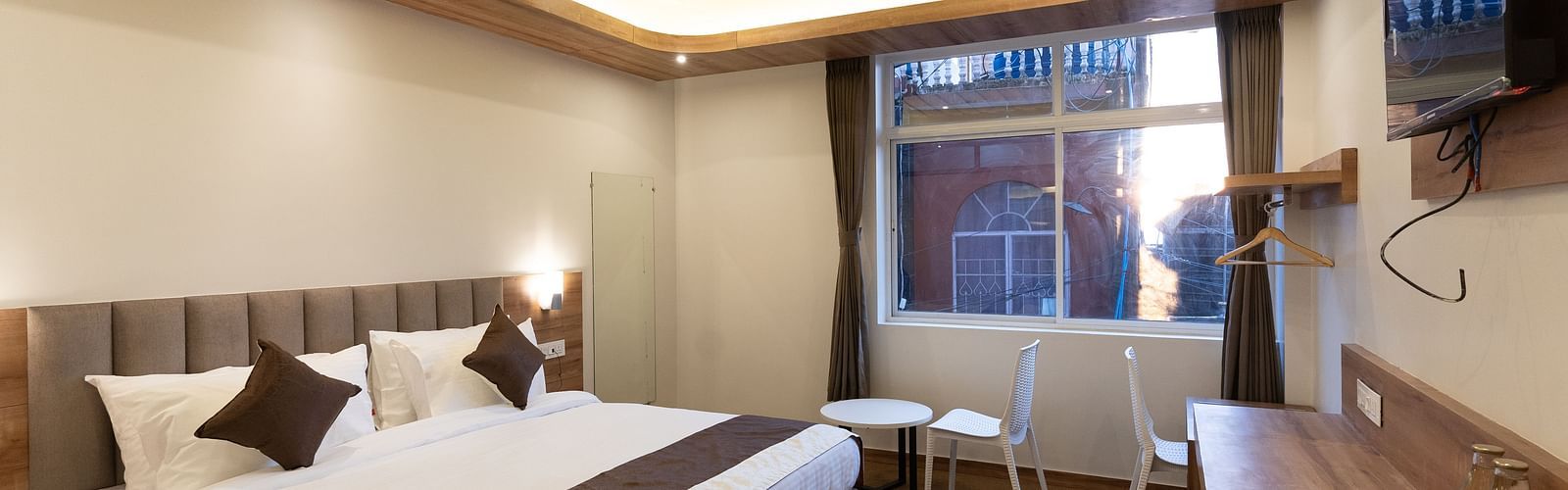 image of the standard room with a window in the corner at The Soma Hotel by Avianna Group, Darjeeling