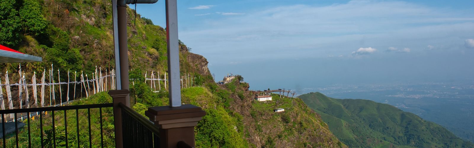 Valley view from a balcony showcasing mountains and clear sky