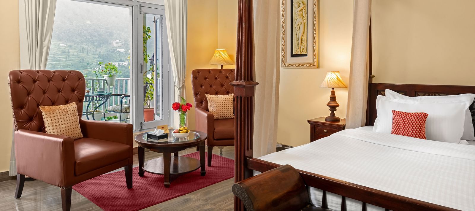 Elegant bedroom with a cosy seating area and a mountain-view balcony at BluSalzz Collection - Suvaasa Resort, Ramgarh.