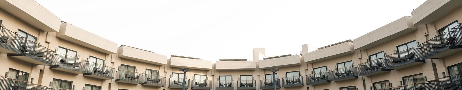 Symmetrical view of hotel facade with pool and garden at Ramada by Wyndham Sonipat Murthal