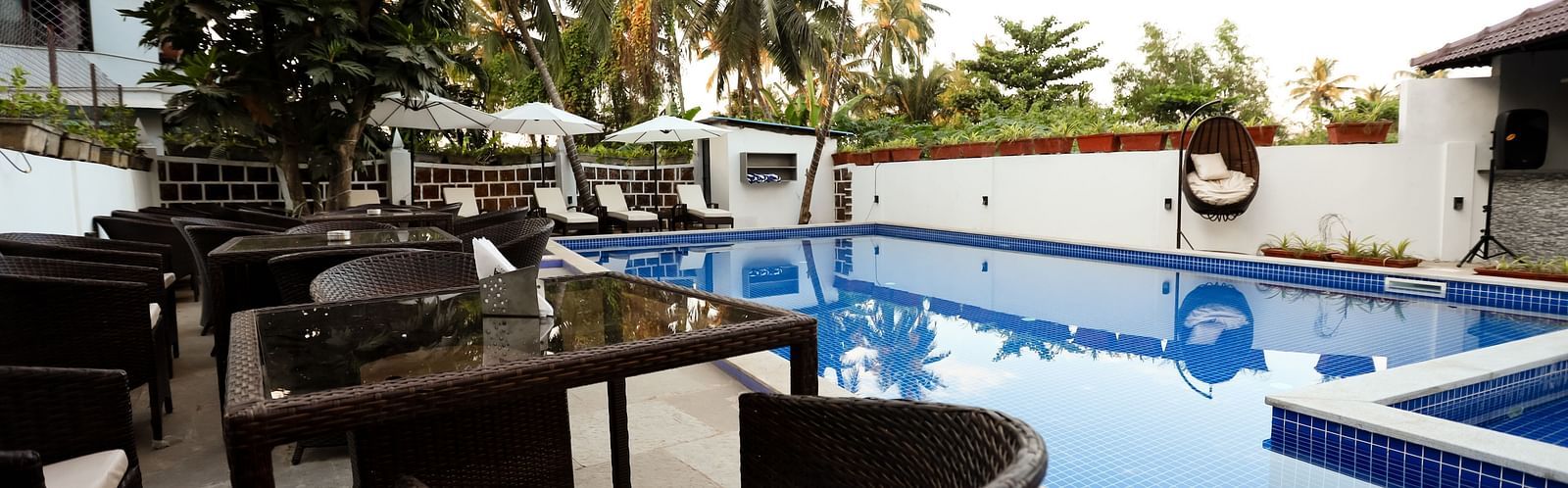 Image of a seating area beside a swimming pool at Calux Grand Baga.